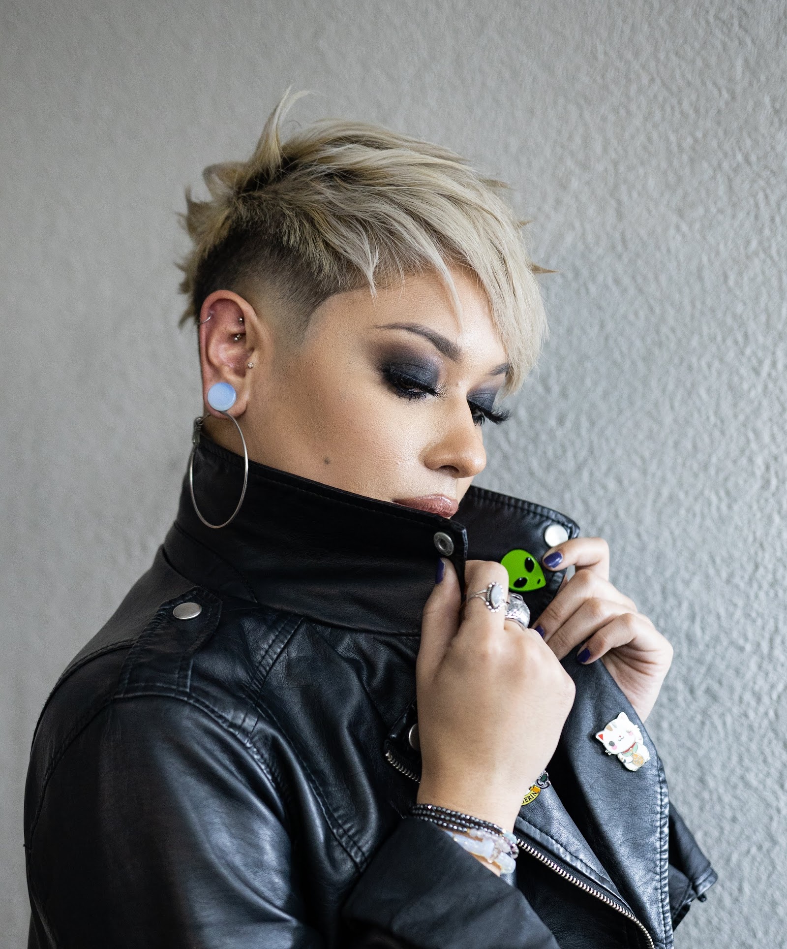 Person with blonde textured pixie cut and shaved sides