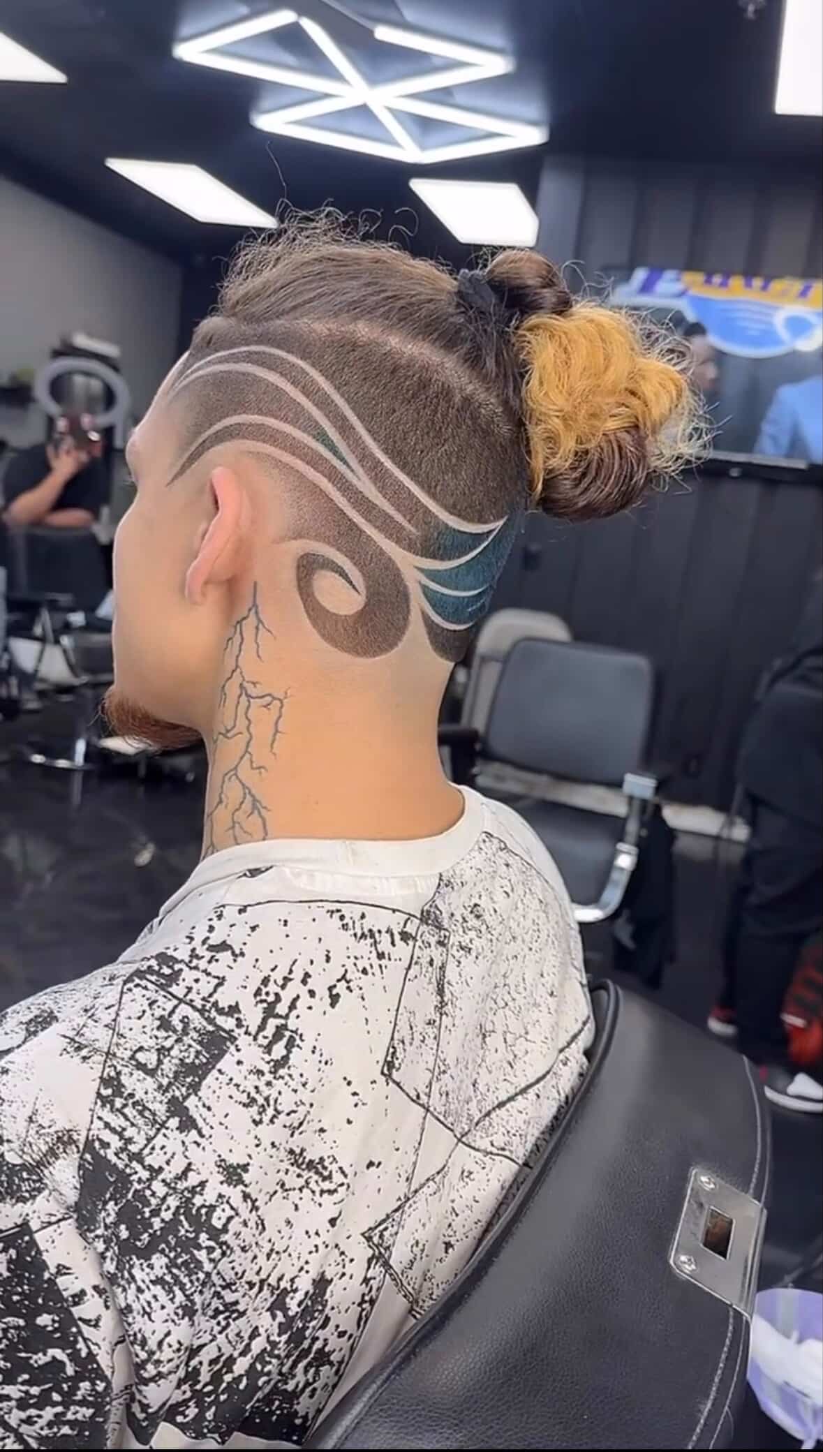 Back of head showing intricate hair design with curved lines and color